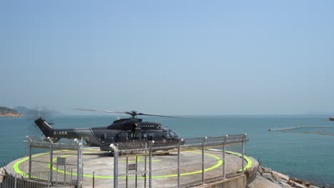 A-hong-kong-medical-service-rescue-helicopter-on-standby-at-the-Cheung-Chau-helipad-next-to-a-beach