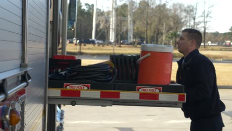 Firefighter-checks-gear-on-a-fire-truck-early-in-the-morning-to-prep-for-emergency-response