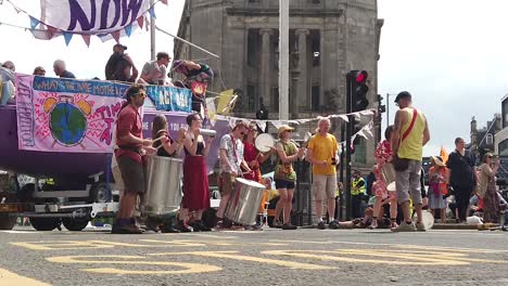 Slow-motion-of-Extinction-Rebellion-protesters-playing-music-in-front-of-a-purple-boat
