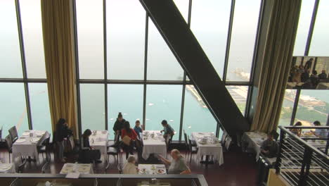 Restaurant-view,-on-top-of-Hancock-tower,-Chicago,-United-States,-Usa,-aerial-view,-skyscraper,-window-panorama,-cityscape,-people,-couples-eating-in-restaurant,-bar