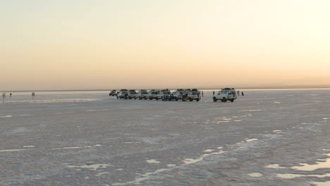 Aerial-view-of-jeeps-and-people-on-adventure-in-Dallol-in-Ethiopia-at-sunset