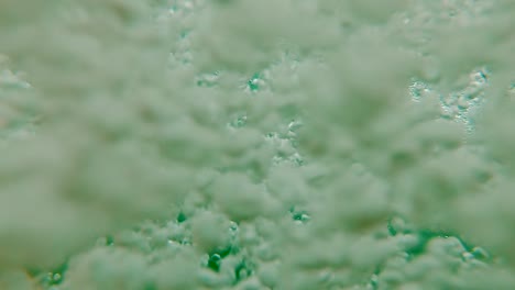 Jumping-into-Underwater-Bubbles-in-Slow-Motion-in-Clear-Blue-Lake-and-Swim-Up-to-Air,-POV-Moving-Through-Dense-Cloud-of-Soft-Focus-Bubbles-toward-Bright-Shining-Summer-Day-Sun