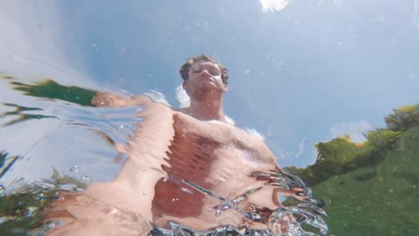 Young-White-Man-Psychedelic-Selfie-from-Underwater-in-Sun,-Slow-Motion