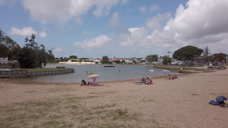 Summer-at-la-Phibie-seawater-basin,-artificial-leisure-beach-in-the-town-of-Chateau-d'Oleron,-France