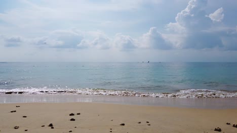 Landscape-view-of-the-white-sea-sand-beach-in-summer-daytime-with-some-wave-and-wind-blowing-in-Phuket,-Thailand---in-slowmotion-4k-UHD-video