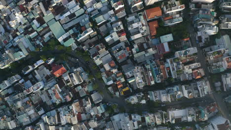 Early-morning-top-down-aerial-view-from-high-angle-looking-down-on-rooftops,-streets-and-alleyways-of-Binh-Thanh-district-of-Ho-Chi-Minh-City