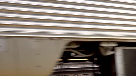 close-up-of-commuter-passenger-train-slowing-down-and-stopping-4k