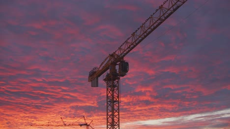 Golden-bluish-clouds-over-construction-site-glow-in-the-light-of-a-sunset