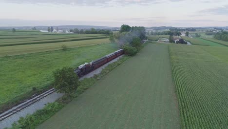 Aerial-View-on-an-Approaching-Steam-Passenger-Train-in-the-Amish-Countryside-on-a-Summer-Day