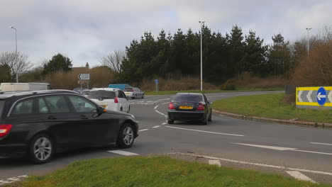 Cars-Passing-through-Busy-Chivvy-Cross-Roundabout-Truro,-Cornwall,-Slow-Motion