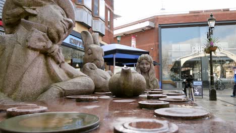 Mad-hatter-tea-party-granite-carved-sculpture-in-Warrington-town-Golden-square-wide-dolly-left