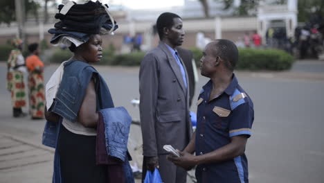 Street-vendor-in-Moshi,-Tanzania-negotiating-with-a-customer