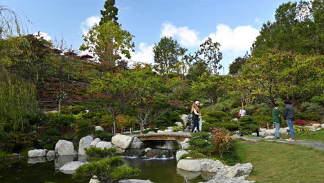 People-enjoying-the-beautiful-scenery-of-a-Japanese-designed-garden-in-Balboa-Park-San-Diego,-California