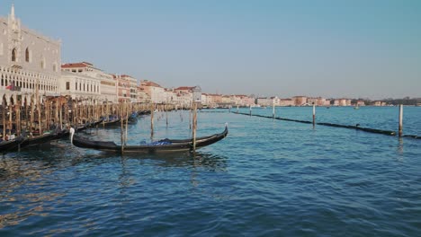 Slow-pan-to-the-left-of-a-gondola-moored-in-the-Gran-Canal-of-Venice-near-the-Patriarchal-Cathedral-Basilica-of-Saint-Mark-square