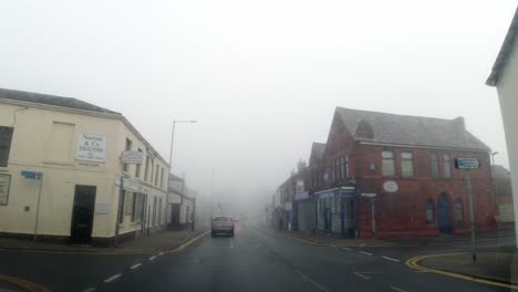 POV-dashboard-driving-in-British-misty-fog-weather-urban-road-traffic
