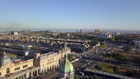 Aerial-view-of-Torre-Monumental-and-Retiro-railway-station-revealing-Rio-de-la-Plata-in-background