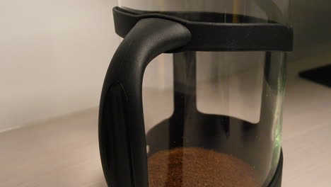 Close-up-of-making-instant-coffee-by-adding-granules-and-heated-water