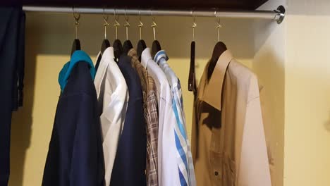 Close-up-on-clothes-hanging-on-a-hotel-closet