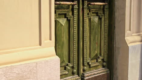 Side-view-of-ornate-green-door-of-building-in-Batumi,-Georgia