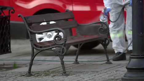 Public-service-worker-disinfects-a-city-bench-in-public-space