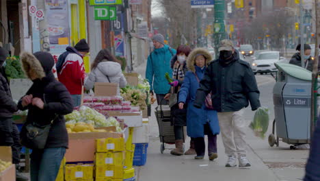 People-wearing-face-masks-shop-for-produce-in-Chinatown,-Toronto