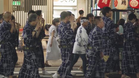 Traditional-Night-Parade-Of-Hiyori-Kagura-On-The-Streets-In-Kyoto,-Japan-During-The-Yoiyama-Festival-At-The-Gion-Matsuri-Festival---Medium-Shot