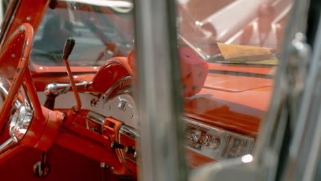 Worn-steering-wheel-on-1957-Ford-Fairlane-500-Convertible-Cockpit-with-fuzzy-dice,-Slide-Right