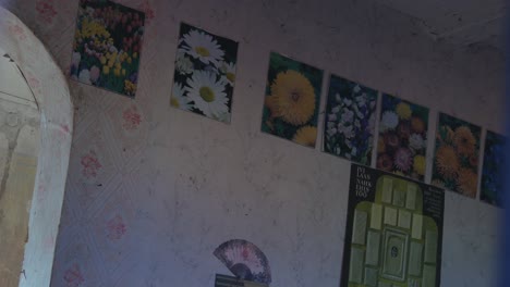 Poster-Mit-Blumenbildern-An-Der-Wand-In-Einem-Alten-Verlassenen-Haus