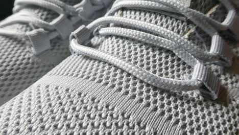 Closeup-dolly-left-on-sports-unbranded-woven-grey-white-comfortable-trainers