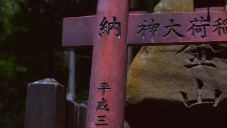 Locked-Off-View-Of-Partial-Torii-Gate-With-Kanji-Writing-At-Fushimi-Inari-Taisha,-Kyoto