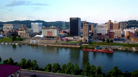 Aerial-Charleston-West-Virginia-Skyline-reveal-over-the-treetops