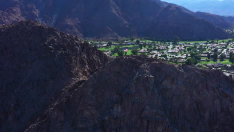 Reveal-of-epic-cliff-Indio-mountain-city-blocks-aerial