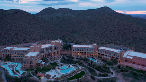 Drohne-Kreist-Vor-Sonnenaufgang-über-Dem-Starr-Pass-Resort-Und-Spa-In-Tucson,-Arizona,-Mit-Den-Grünen-Bergen-Im-Hintergrund