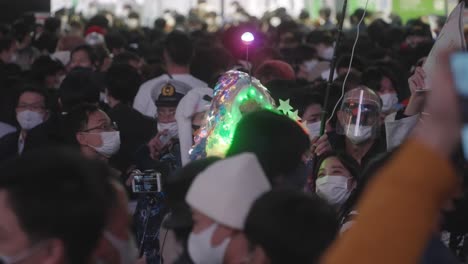 A-Person-Wearing-A-LED-Halloween-Costume-Having-A-Selfie-With-A-Young-Girl-On-Halloween-Night-At-Shibuya-Crossing-In-Tokyo,-Japan---Medium-Shot