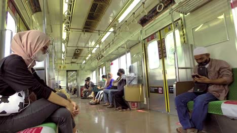 a-Muslim-woman-sitting-on-a-commuter-line-during-the-coronavirus-pandemic