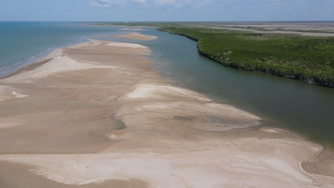Aerial-drone-shot-of-Buffalo-creek-Leading-to-ocean,-with-Sandy-beach-and-Dense-bushland-near-Lee-Point,-Darwin,-Northern-Territory
