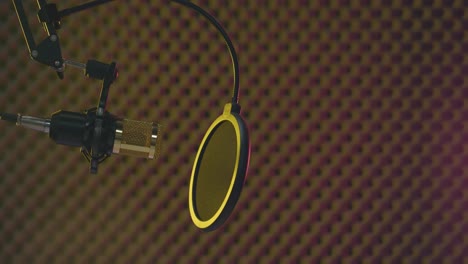 Static-view-of-a-golden-microphone-in-a-smoke-filled-professional-recording-studio