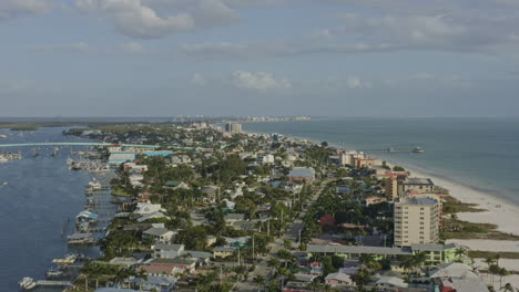 Fort-Myers-Beach-Florida-Aerial-v15-pan-right-shot-of-Matanzas-Pass-Bridge,-harbor,-coastline-and-Gulf-of-Mexico---March-2020
