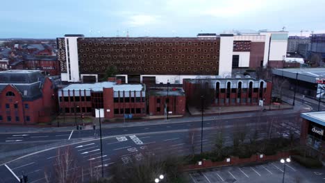 Early-morning-aerial-Warrington-England-city-street-multi-storey-carpark-rooftop-townscape-slow-right-pan