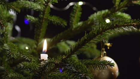 Candle-on-Christmas-tree-blown-out,-festive-household,-closeup-slow-motion
