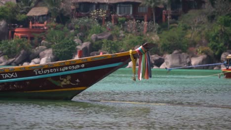 Colorful-Ribbons-Blessing-Thai-Long-Tail-Water-Taxi-Moored-Along-Beach