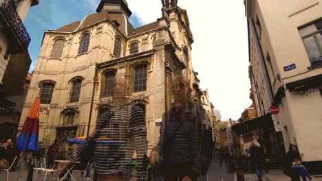 People-walking-and-sitting-at-cafes,-pedestrian-aerial,-Brussels-,-Belgium