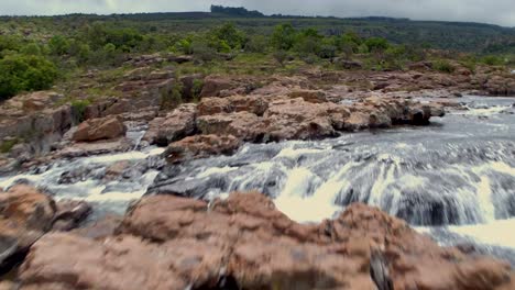 4K-Drone-Aerial-Tracking-over-Amber-Treur-Falls,-Just-up-stream-from-the-well-known-Bourke´s-Potholes-rock-formation-location-in-Mpumalanga,-South-Africa