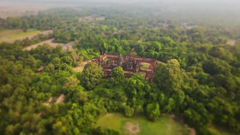 Angkorian-temple,-Banteay-Samre-,-nested-in-the-mystic-Cambodian-jungle,-aerial-drone-footage-tilt-shift-effect