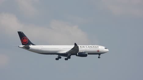 Close-up-shot-of-Air-Canada-passenger-airplane-flying-through-a-clear-sky-during-the-day-at-Toronto-International-Airport