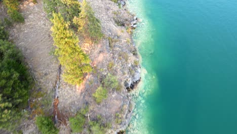 Aerial-vertical-view-flying-over-beautiful-turquoise-water-of-kalamalka-lake-in-British-Columbia-Canada