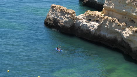 Unrecognizable-kayakers-on-Benagil-coast-on-sunny-day