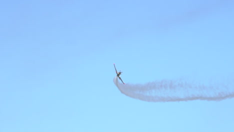 Aerobatic-Airplane-rotating-and-leaving-White-Smoke-Trail