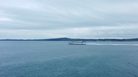 Irish-Ferries-passenger-transport-vessel-journey-across-Irish-sea-leaving-Holyhead-to-Dublin-aerial-view-pan-left