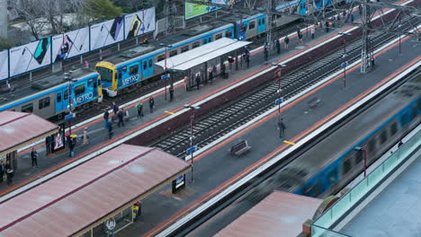 Morning-rush-hour-time-lapse-looking-down-on-trains-and-passengers-at-the-South-Yarra-railway-station-in-Melbourne,-Australia